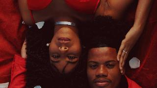 couple-dressed-in-red-lying-together- from opposute sides