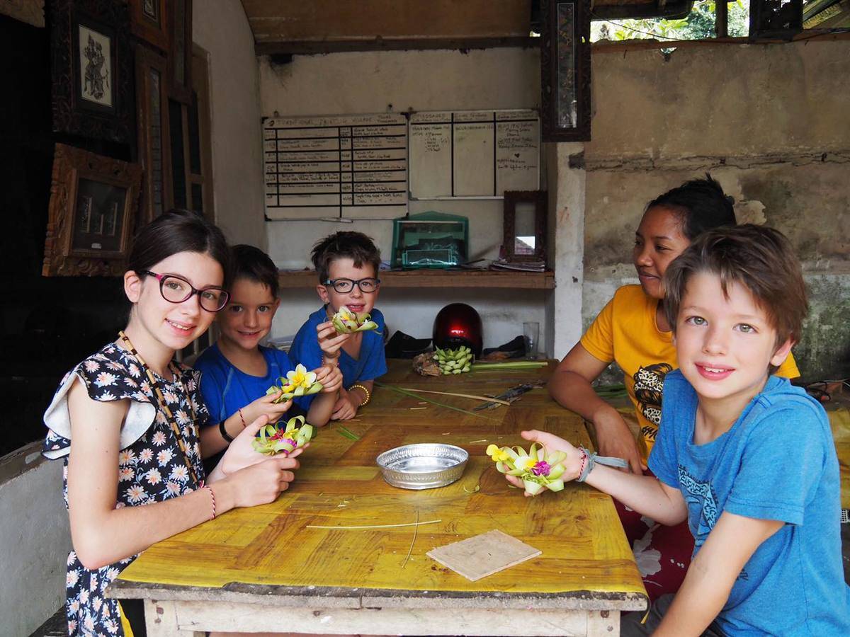 kids smile at table making flowers