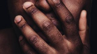 man hides his face with hands (closeup)