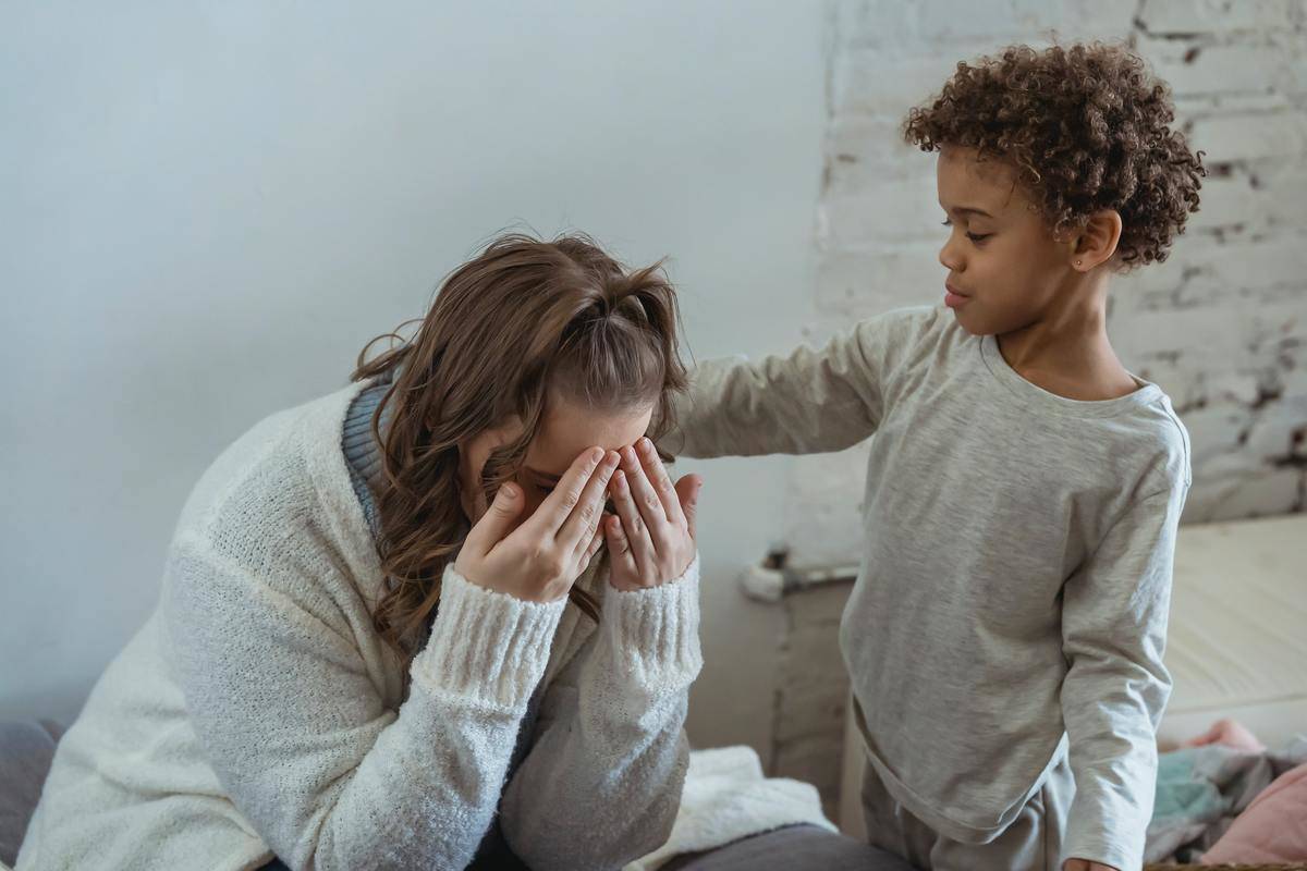 black-son-comforting-anonymous-mother