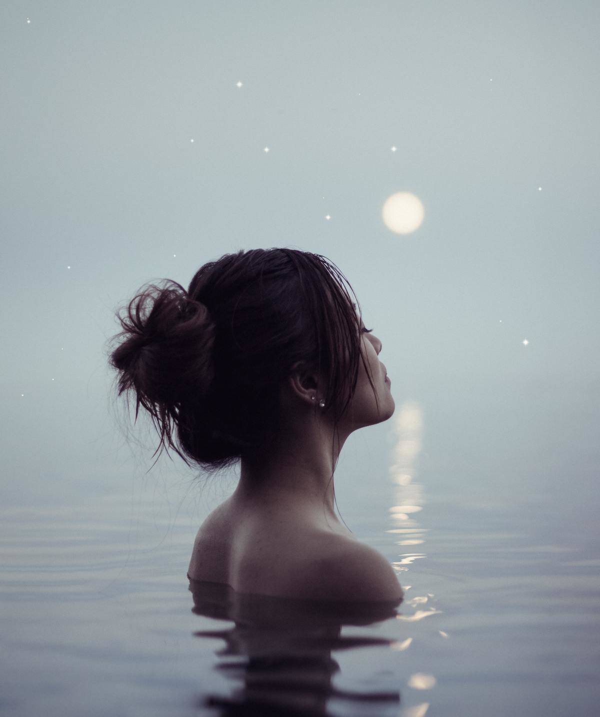 woman bathing by full moon in lake