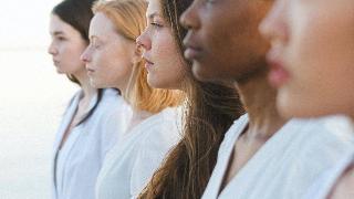 photo-of-beautiful-women-in-white-outfit looking forward stadig beside eachother