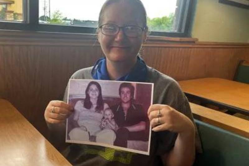 The former Holly Marie Clouse with a photo of her parents Dean and Tina Clouse, who were found murdered in Houston in January 1981 moments after meeting Texas investigators. 