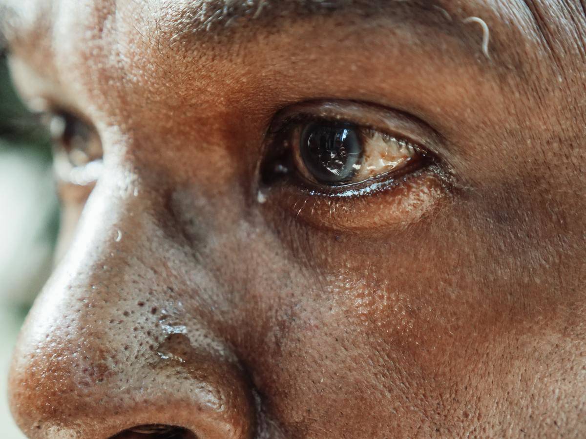 close up of man's face with eyes wellig up