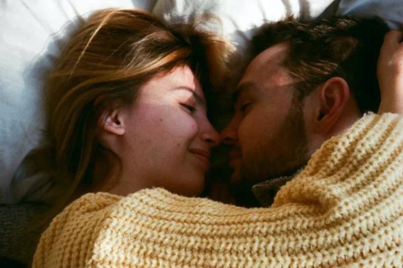 oman-in-knit-sweater-lying-on-bed-with-a-man