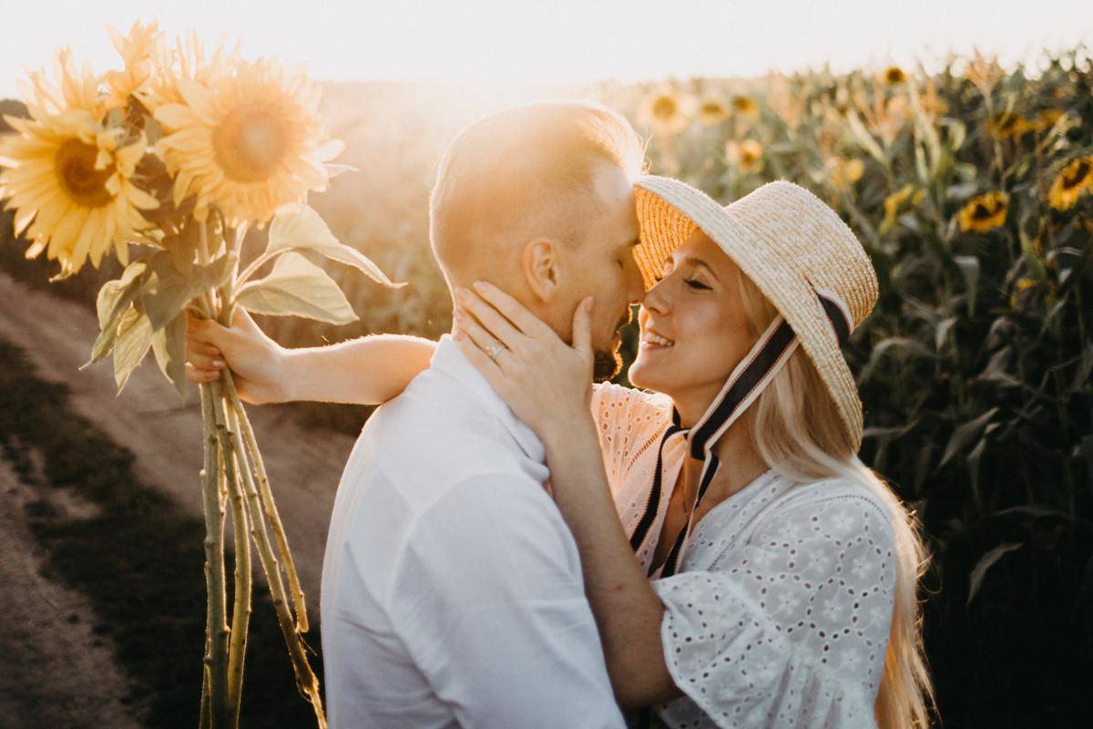 -couple-about-to-kiss-each-other-in sunflower filed