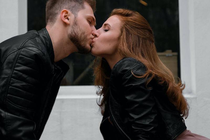 kissing-couple-wearing-black-jackets-