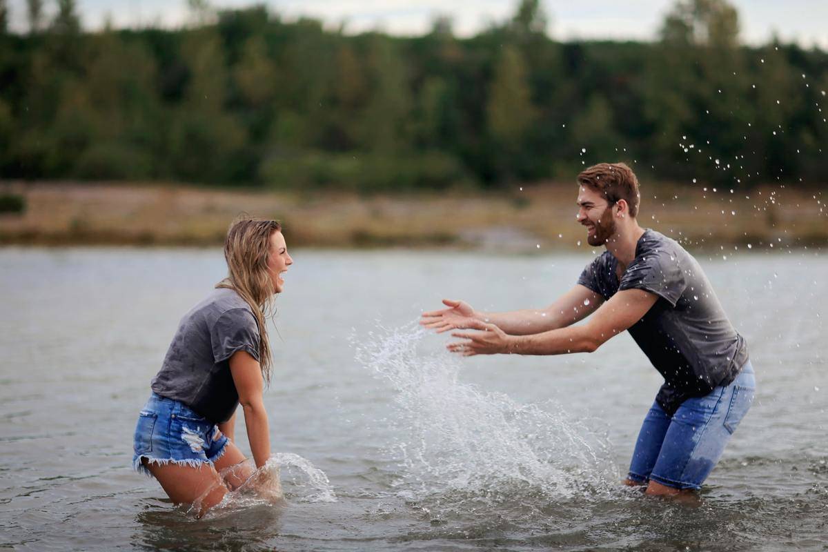an-and-woman-playing-on-body-of-water-