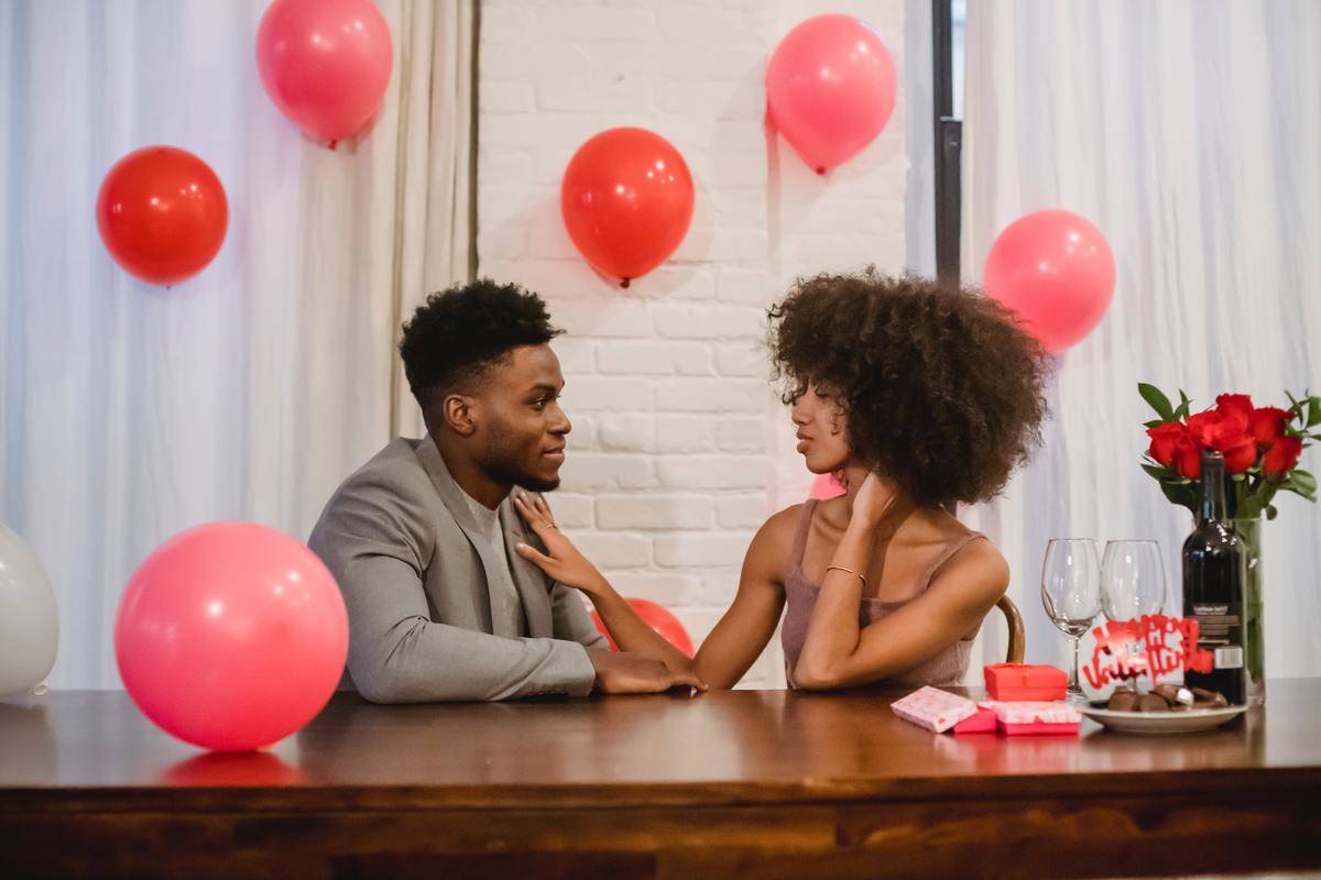 black-couple-celebrating-holiday-while-having-conversation-at-table-
