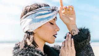 woman with zodiac sign closes her eyes