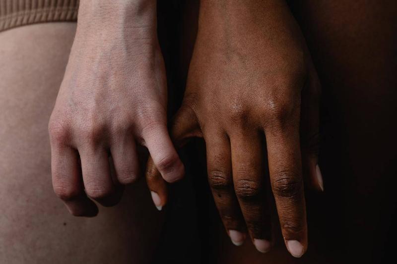 white and black women-holding-pinky-fingers