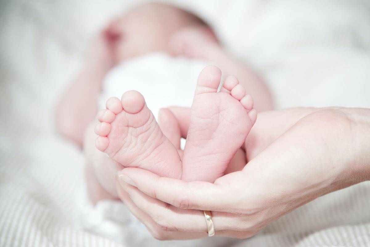 close-up-of-hands-holding-baby-feet