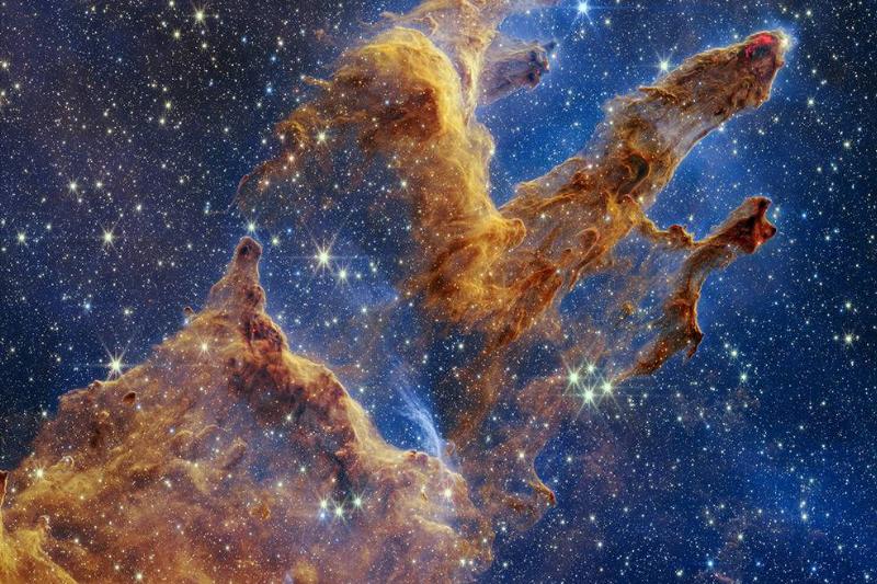 The Pillars of Creation are set off in a kaleidoscope of color in NASA's James Webb Space Telescope’s near-infrared-light view. The pillars look like arches and spires rising out of a desert landscape, but are filled with semi-transparent gas and dust, and ever changing. This is a region where young stars are forming – or have barely burst from their dusty cocoons as they continue to form.