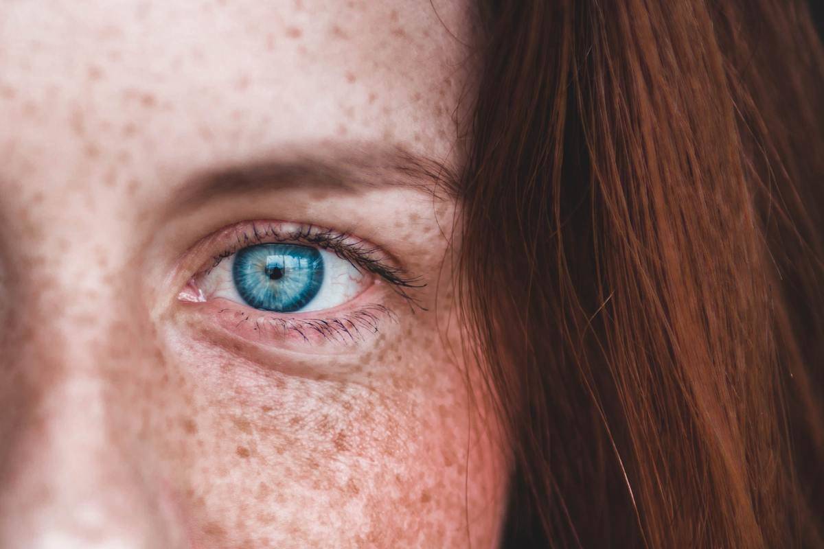 closeup of woman with blue eyes and yellow specle