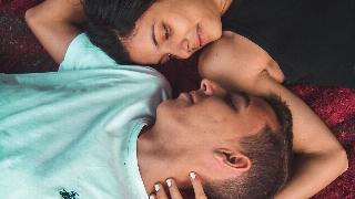 pcouple-lying-on-ground-while-holding-their-hands-