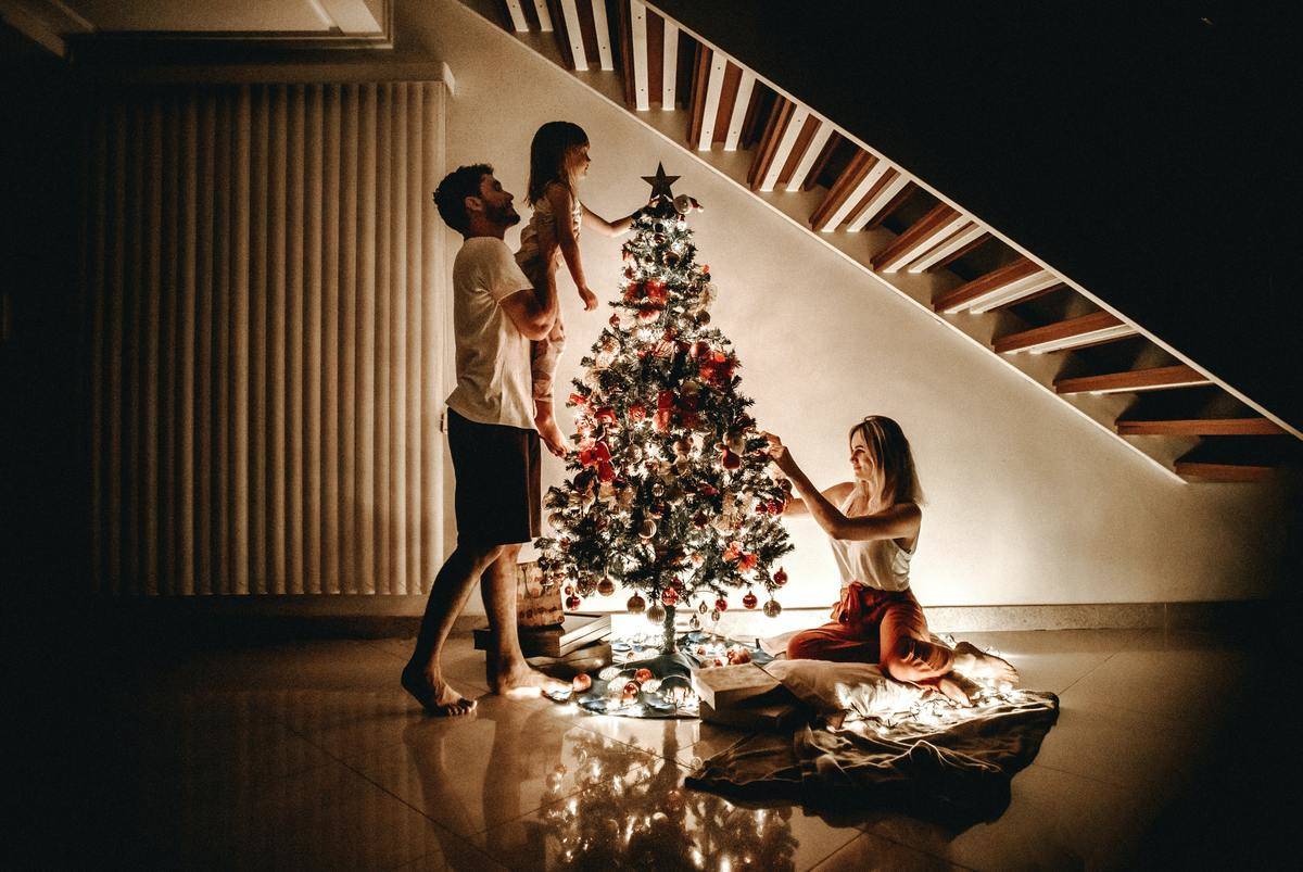 family-decorating-their-christmas-tree-