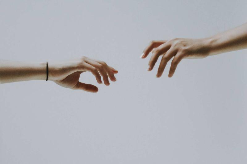 couple-of-hands reaching for each other