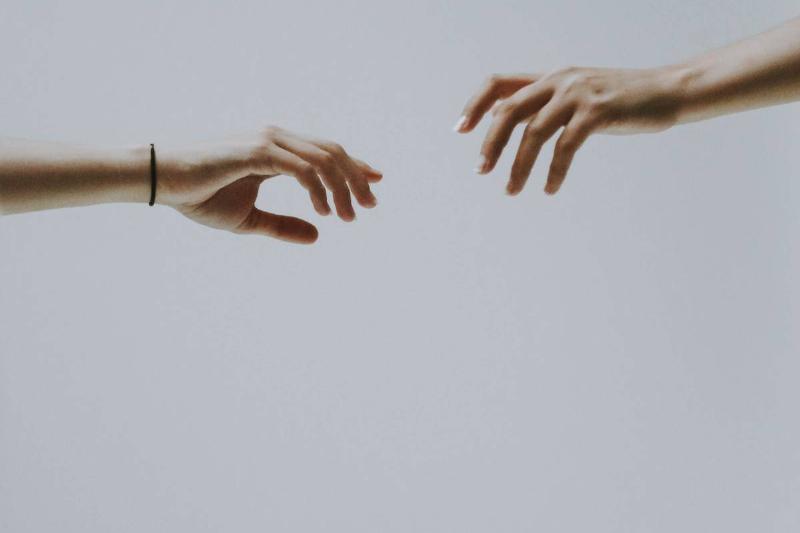 couple-of-hands- reaching for each other from opposite sides