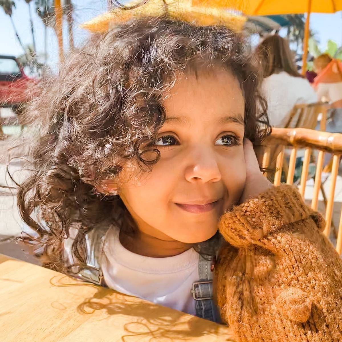 little girl smiling at outdoor table