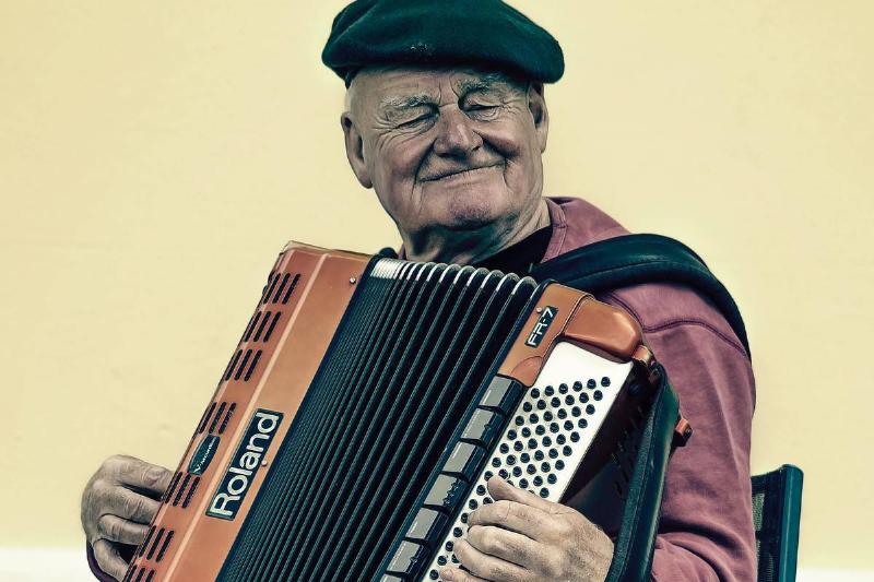 man-sitting-playing-accordion-