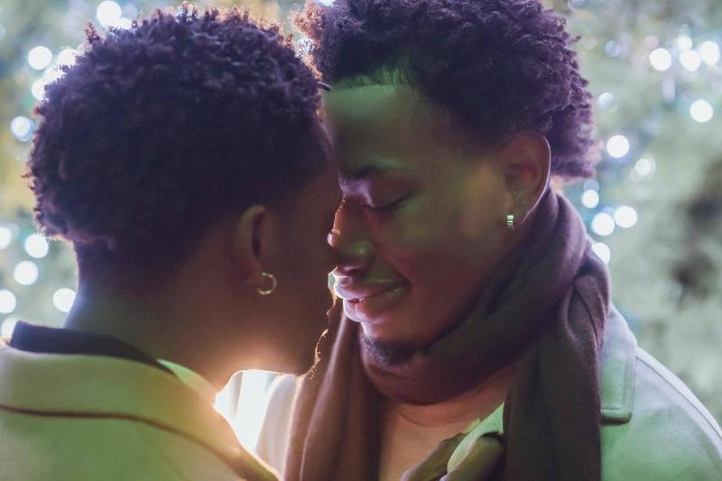 happy-young-black-gay-couple-hugging-with-closed-eyes-on-street-at-nigh