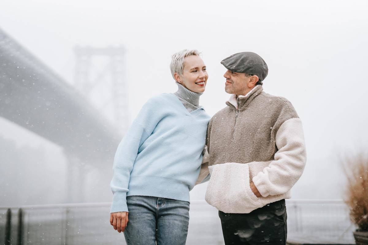 smiling-couple-talking-on-embankment-on-foggy-day