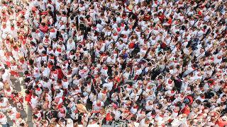 overcrowded population with people all dressed in white and red