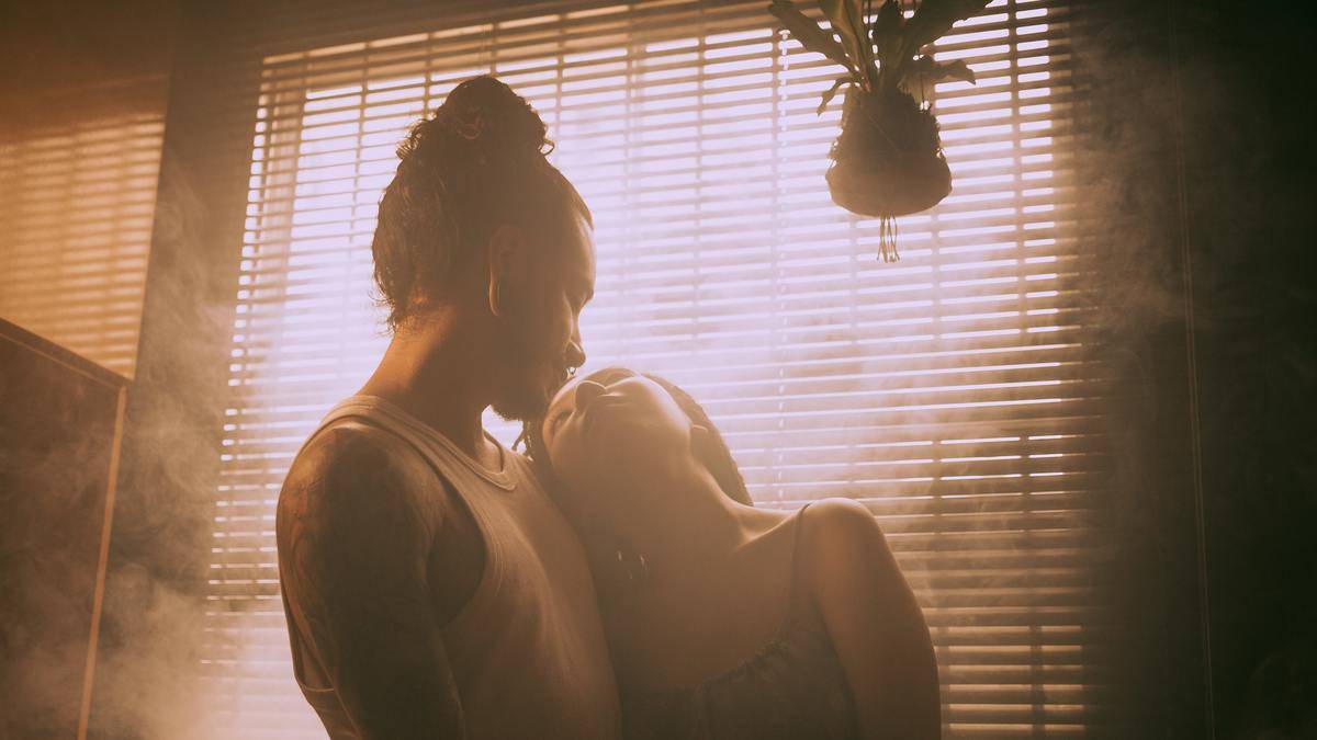 couple-hugging-near-window-in-smoke