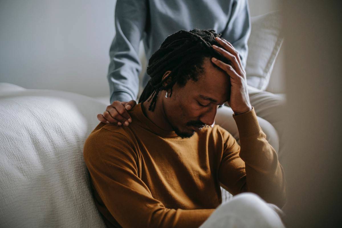 orrowful-black-man-touching-head-in-dismay-near-supporting-wife