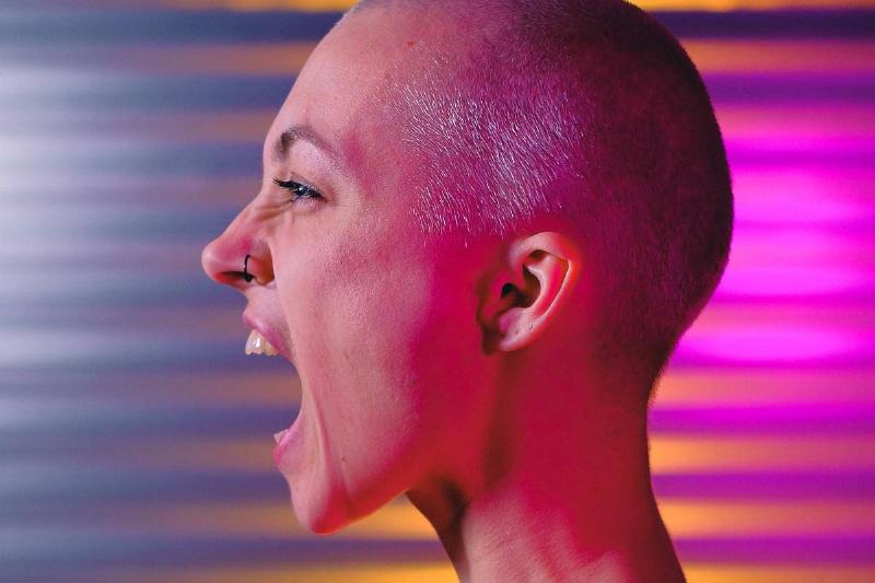 expressive-bald-woman-shouting-in-studio