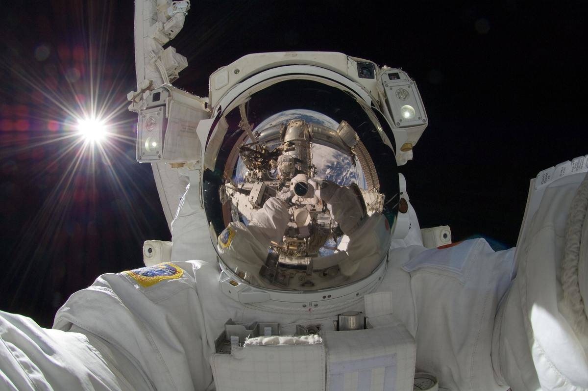 Astronaut holds camera in space