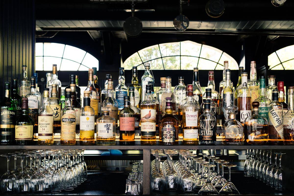 A bar covered in bottles of alcohol.