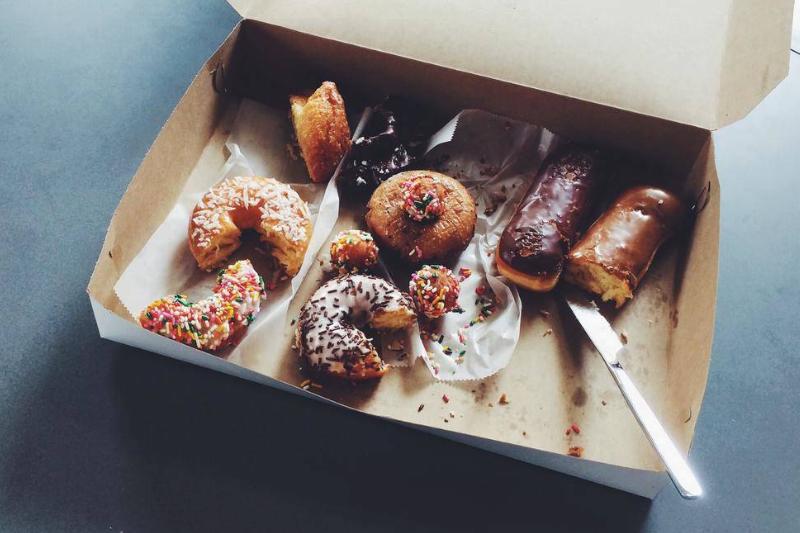 A box of half-eaten doughnuts.
