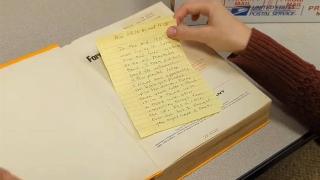 A screenshot from the library's video of the book, showing the letter inside.