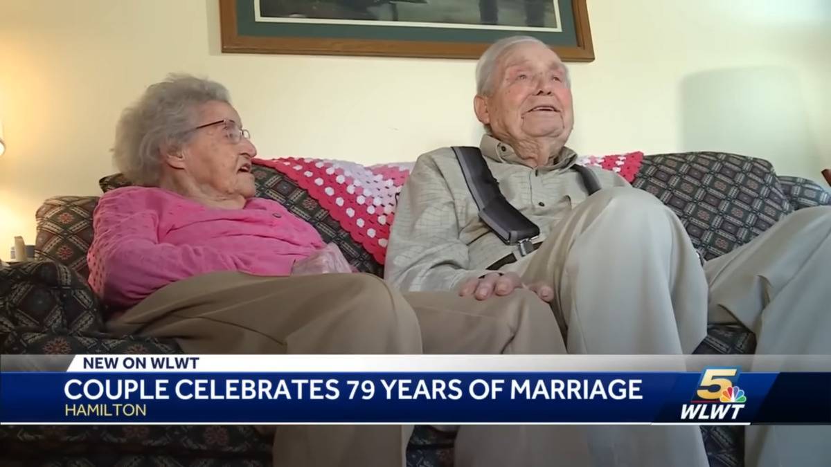 June and Hubert sitting next to one another while being filmed for WLWT.