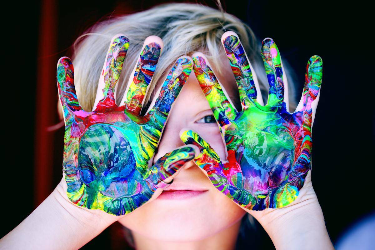 a-kid-with-multicolored-hand-paint