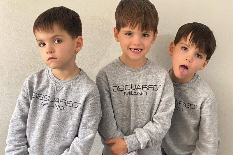 kids now pose in matching hoodies