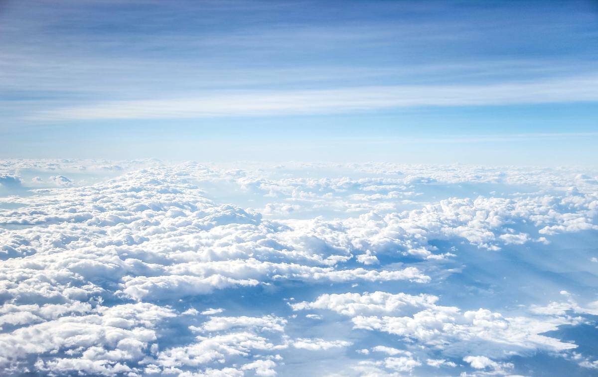 A view above a layer of clouds in the sky.