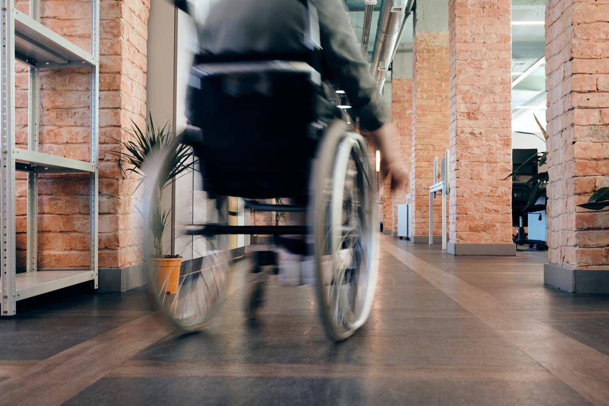 Someone riding in a wheelchair down the hall.