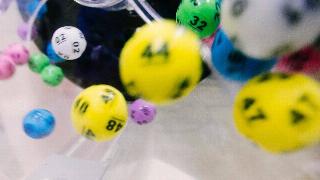 Lottery powerball balls spinning in a plastic container