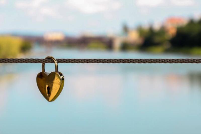 A heart-shaped lock on a wire.