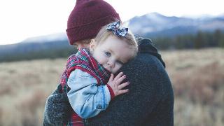 an-carrying-a-baby hugging