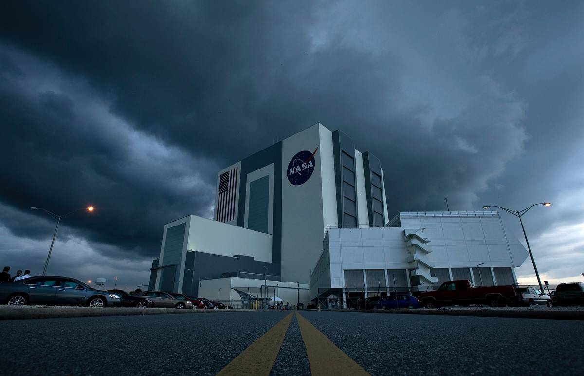 One of NASAs headquarters with a dark, cloudy sky overtop.