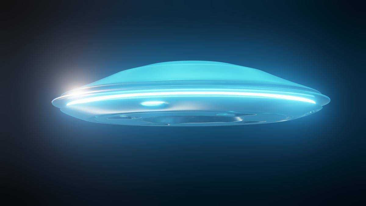 A bright blue glowing UFO against a dark background.
