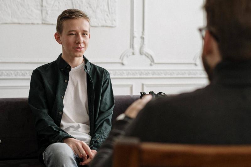 A young man speaking to a therapist.