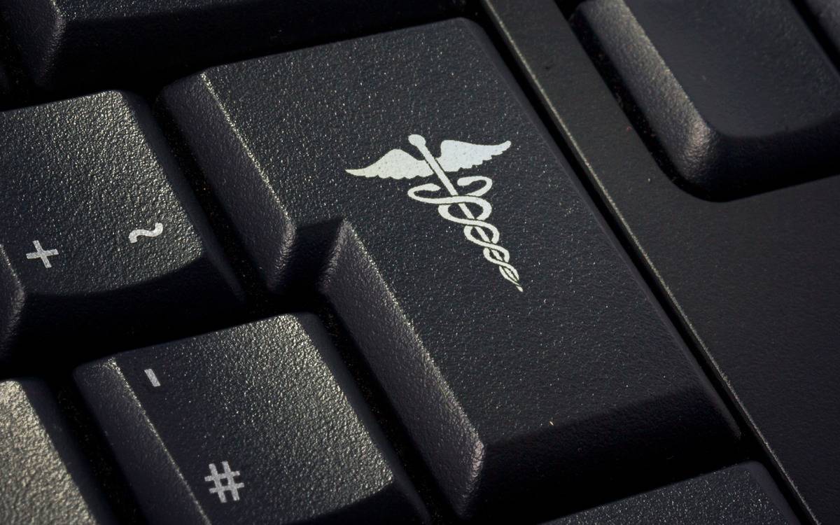 A key on a keyboard with the staff of Asclepius on it.