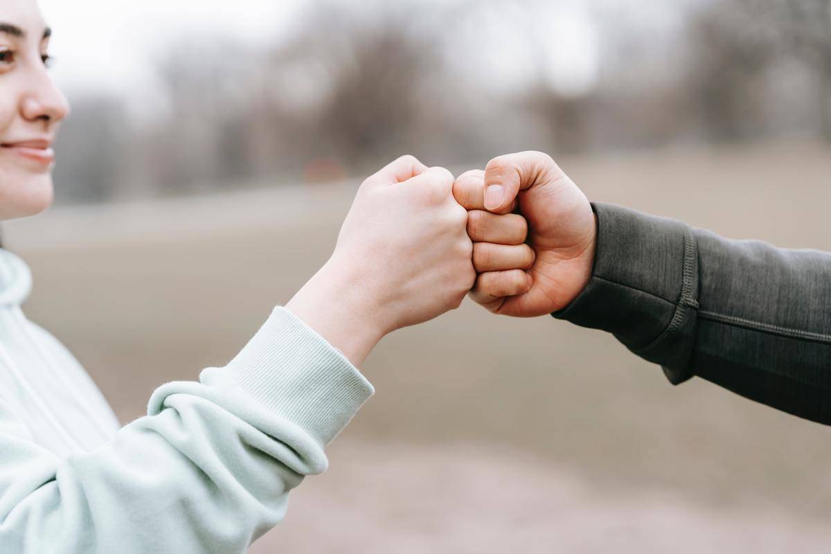 Two people fistbumping.