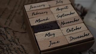 A set of stamps in a box, one for each month.