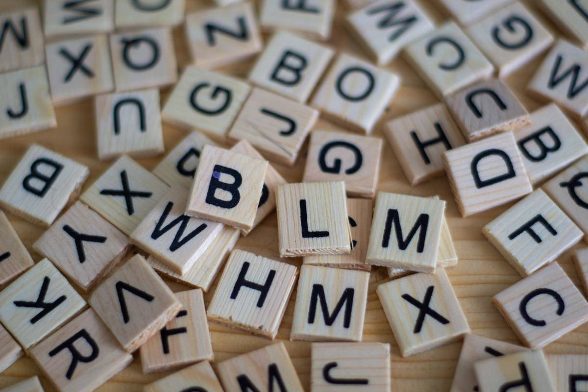 Scrabble letter tiles scattered on a table.