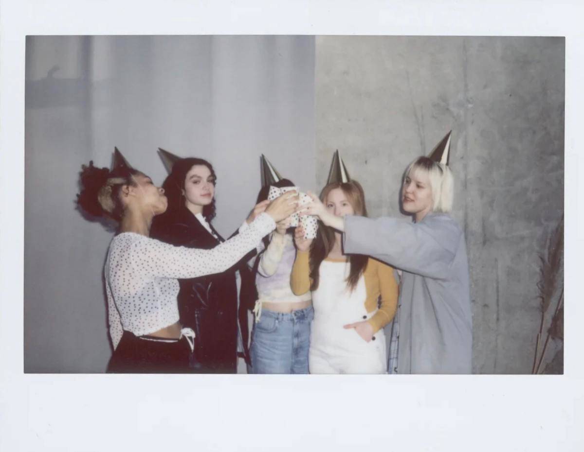 -picture-of-women-toasting-while-wearing-party-hats-